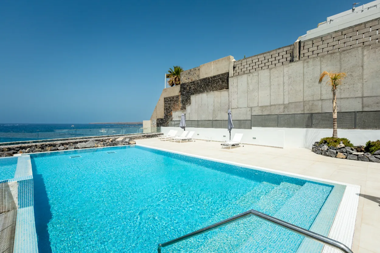 Vista del Silencio - pool-terrace-with-loungers-and-stone-wall